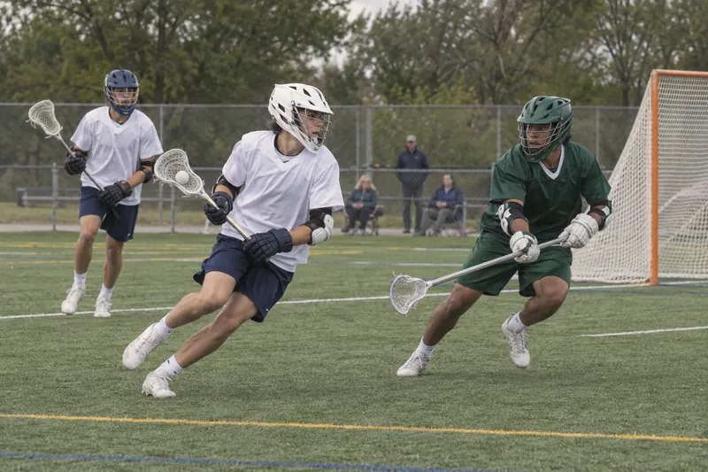 Youth lacrosse players running with their sticks