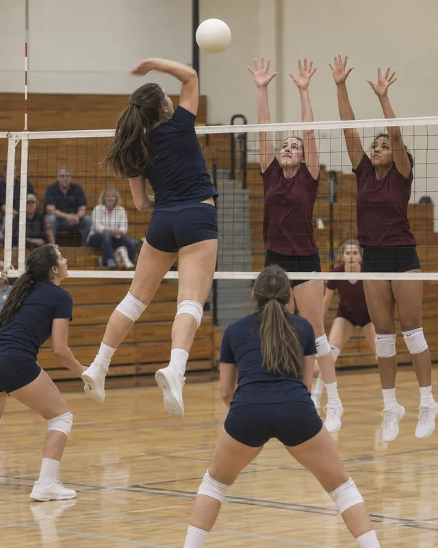 Girls' youth volleyball players at the net